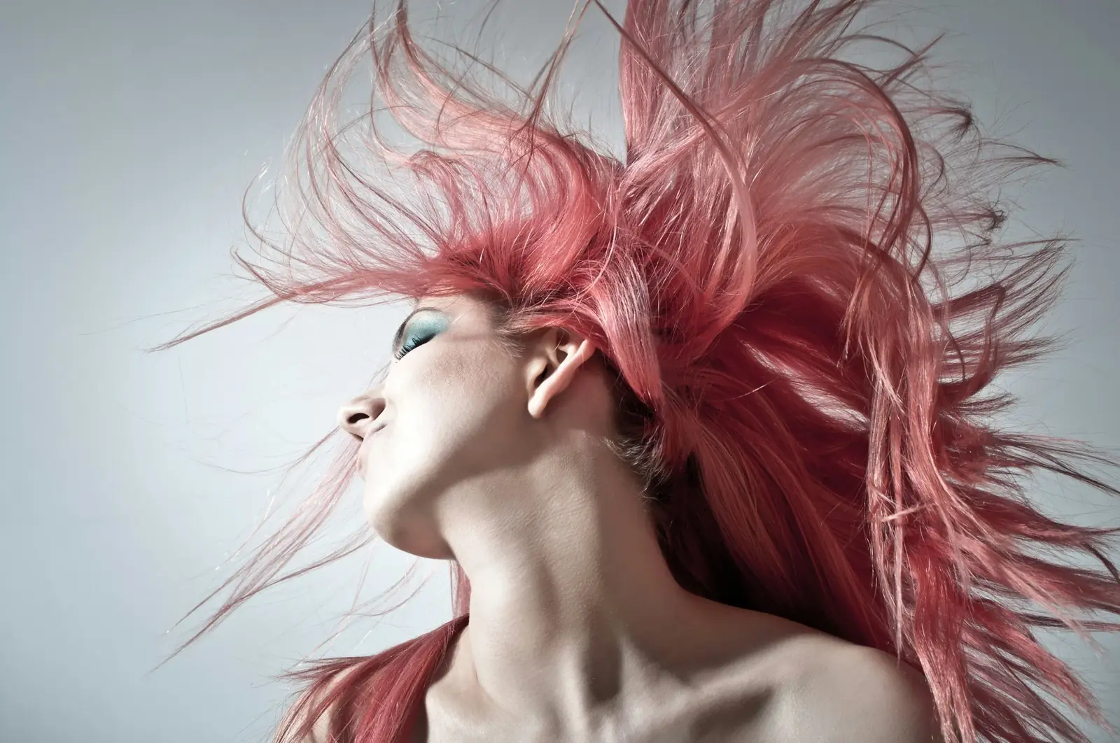 Model with vividly colored hair, representing the creative color services cosmetologists learn