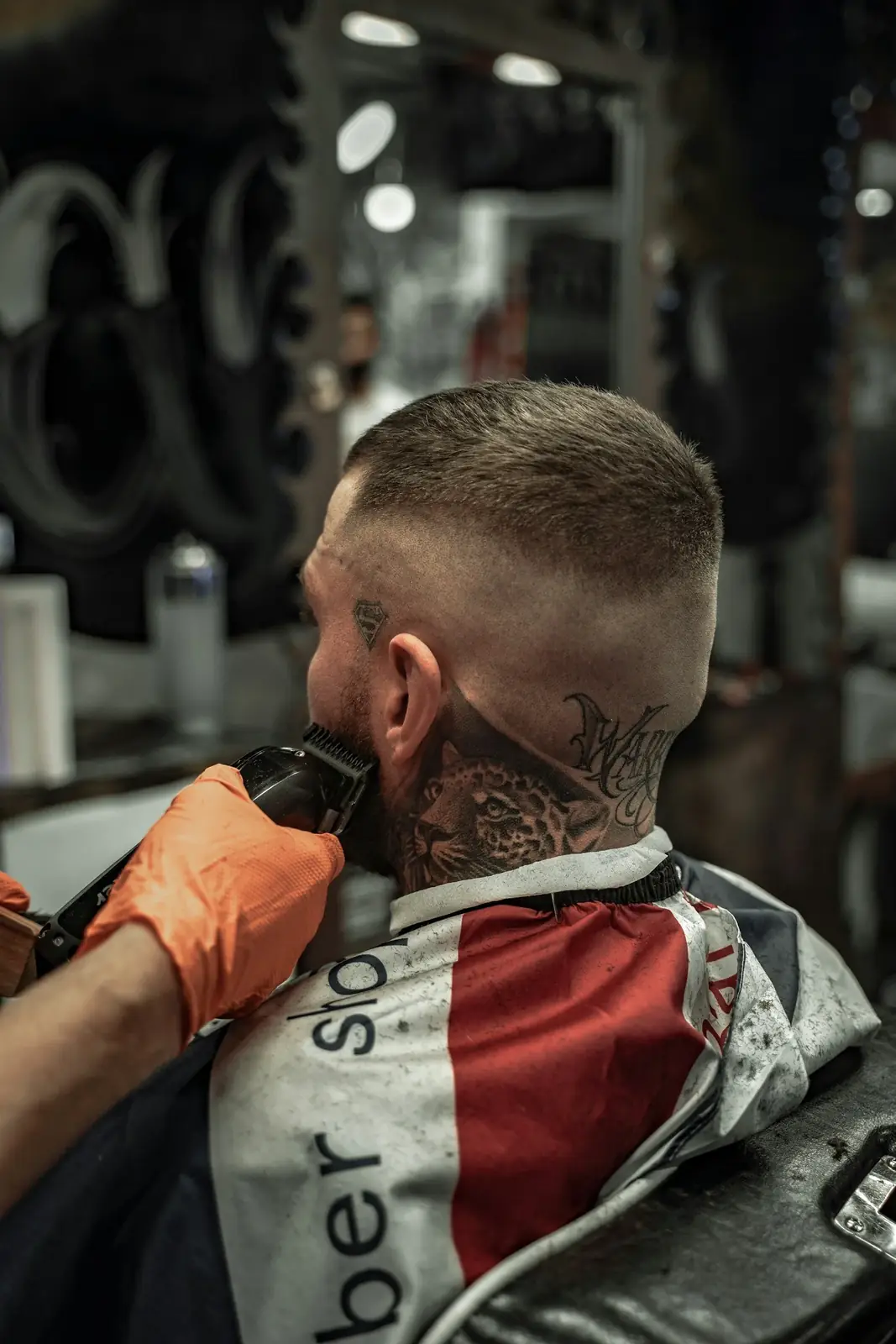 Barber performing a precision neckline shave, a skill covered in the Class A Barber crossover program